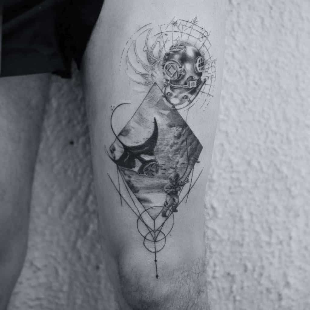 Intricate ocean-themed thigh tattoo featuring a vintage diver's helmet, manta ray, deep-sea diver, and geometric elements