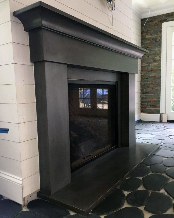 Traditional concrete fireplace with a bold mantel and a smooth, polished finish, perfect for a classic and elegant look.