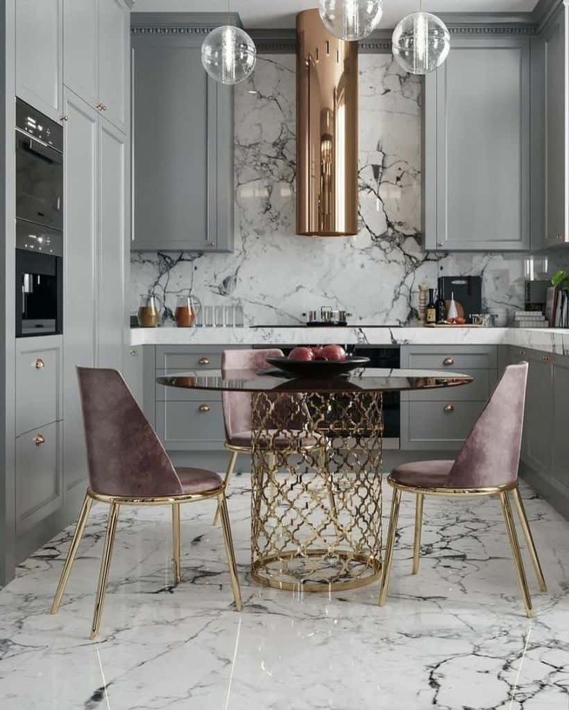 elegant kitchen with gray cabinets marble flooring and backsplash gold accent table and purple chairs