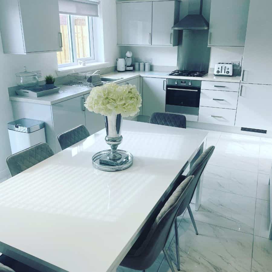 all white kitchen with white marble floor tiles
