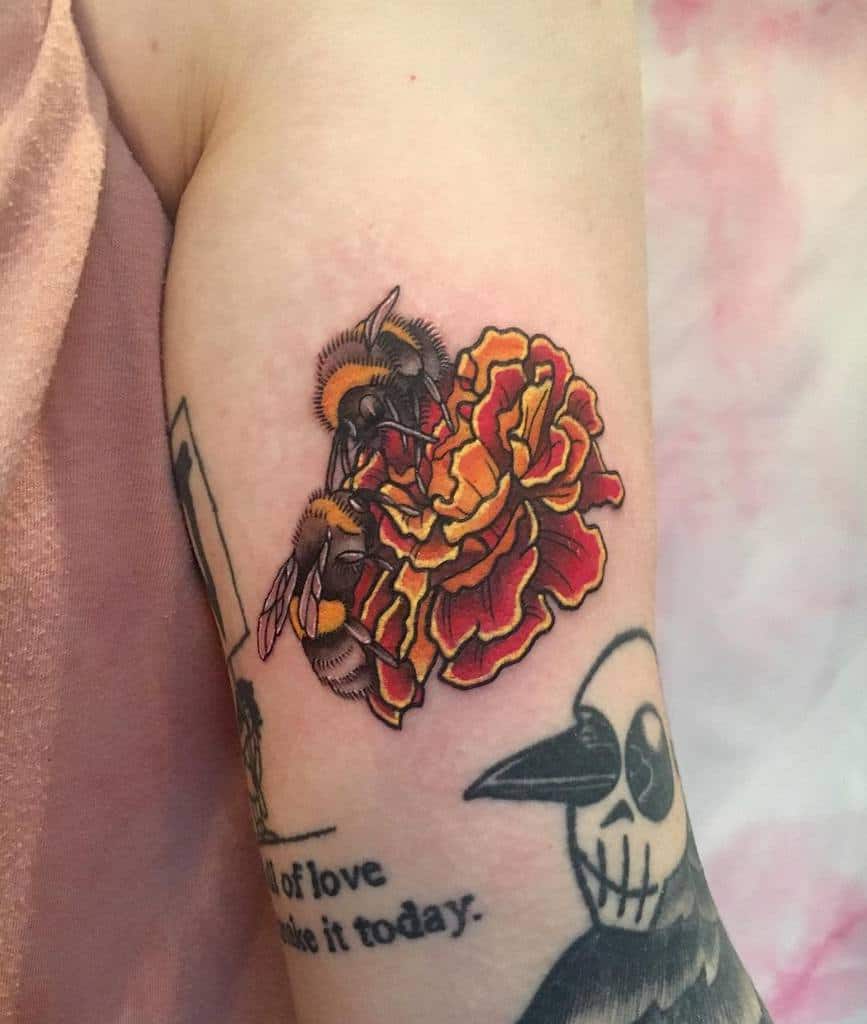 Two bees hovering over a vibrant red and yellow marigold, inked in a bold, detailed style