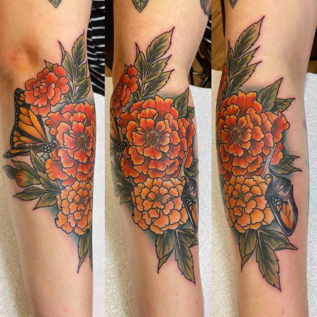 Vibrant tattoo featuring detailed orange marigolds, lush green leaves, and a monarch butterfly, blending bold outlines