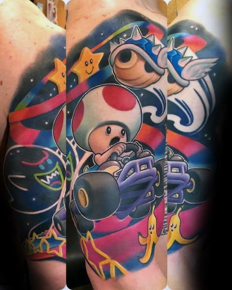 Vibrant Mario Kart tattoo featuring Toad racing, a spiked blue shell, Boo, banana peels, and Super Stars, inked in a colorful, dynamic sleeve design.
