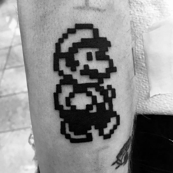 Minimalist black pixel-art *Super Mario* tattoo, featuring a classic 8-bit design for a nostalgic and retro gaming-inspired look.