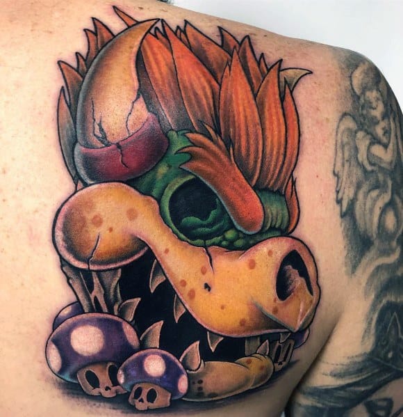 Dark Bowser tattoo on a man's shoulder featuring intense shading, sharp details, and a menacing skull-like design with eerie mushrooms.