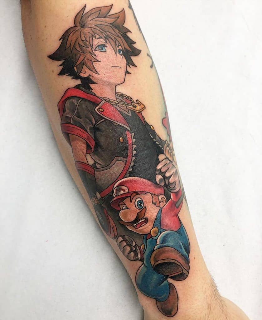 Colorful forearm tattoo featuring Sora from Kingdom Hearts and Mario from Super Mario, both in dynamic poses with detailed shading.