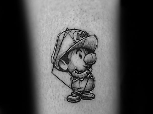 Minimalist black and gray *Baby Mario* tattoo with fine-line shading and geometric elements, capturing a nostalgic and artistic gaming-inspired design.