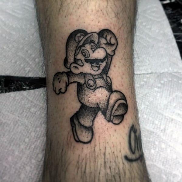 Black and gray *Super Mario* tattoo with dotwork shading, featuring Mario in a classic jumping pose for a nostalgic and timeless gaming design.