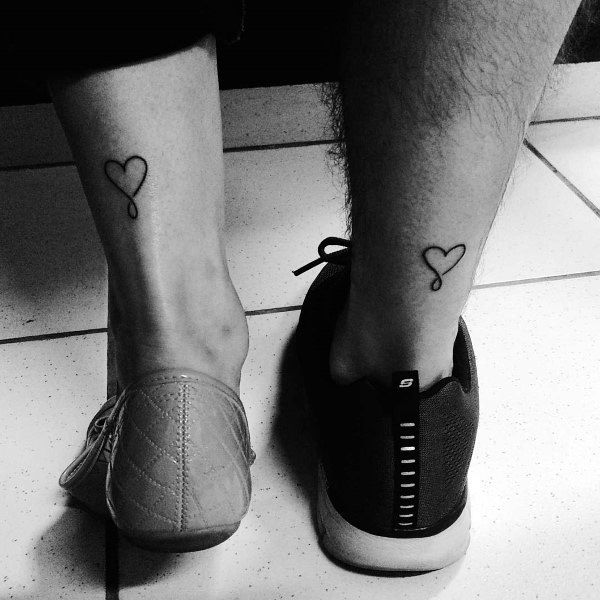 Matching ankle tattoos of simple heart-shaped balloons, symbolizing lightness, love, and a connection that lifts each other up.
