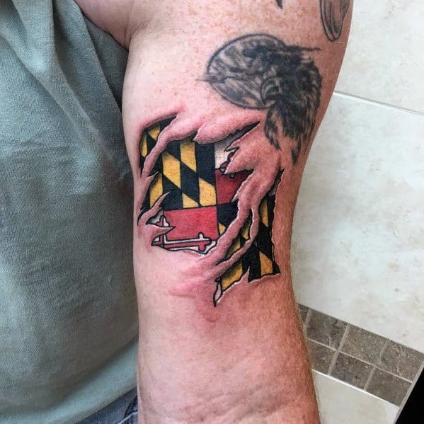 Maryland flag tattoo with a torn skin effect on the forearm, creating a 3D illusion of the flag beneath, symbolizing deep state pride.