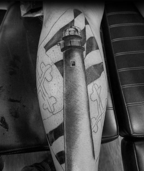 Black and grey lighthouse tattoo with the Maryland flag in the background, blending maritime symbolism with state pride in a bold leg design.