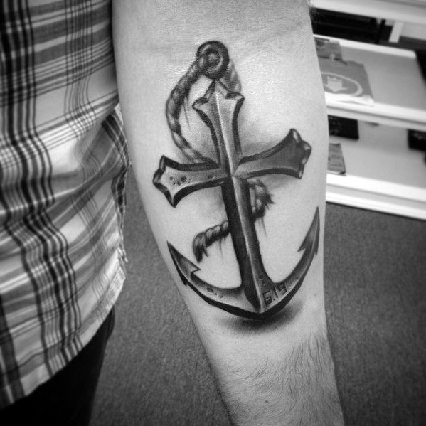 Tattoo of an anchor with rope on forearm, person in a plaid shirt