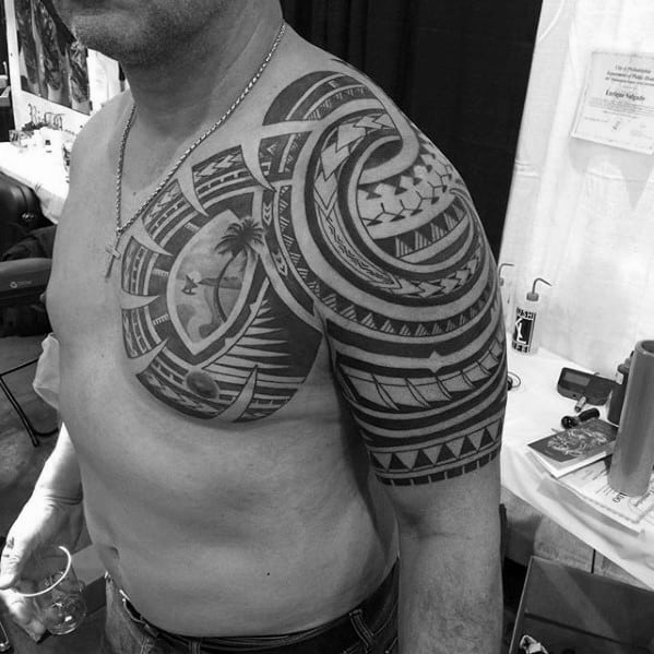 Masculine Badass Tribal Upper Chest And Half Sleeve Tattoos For Men