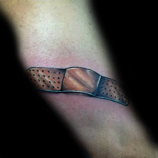 Realistic Band-Aid tattoo with soft shading and subtle highlights, designed to appear as if it’s gently resting on the skin.