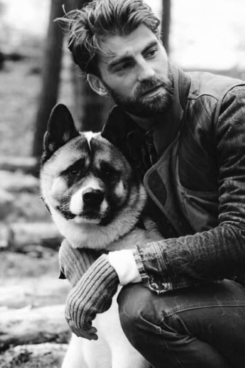 Man with tousled hair and a short beard