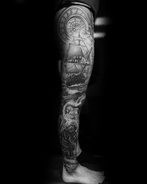 Black and grey full-leg sleeve tattoo featuring a detailed sailing ship, compass, ocean waves, and a mysterious sea creature for a nautical theme.
