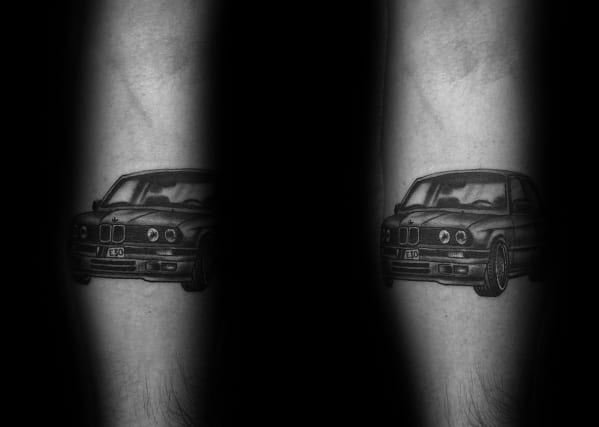 Realistic BMW E30 tattoo on forearm, featuring detailed shading and a bold front-end view for a sleek automotive-inspired design.