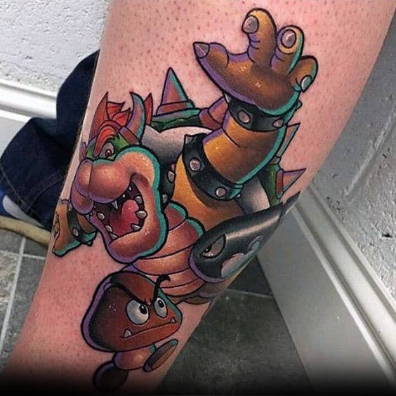 Dynamic Bowser tattoo on a man's leg featuring bold outlines, vibrant colors, and action-packed details with Bullet Bill and Goombas.