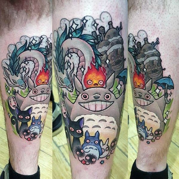 Colorful leg tattoo featuring Calcifer, Totoro, Catbus, No-Face, and other Studio Ghibli characters in a vibrant, whimsical scene.