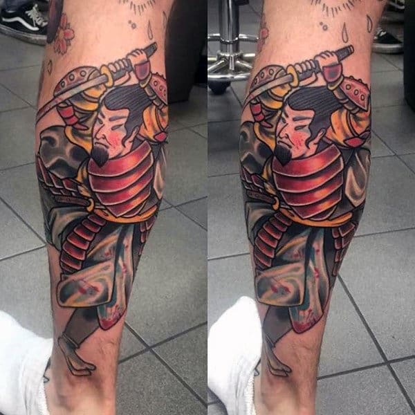 Colorful calf tattoo of a traditional Japanese samurai in red and gold armor, wielding a sword with bold outlines and shading