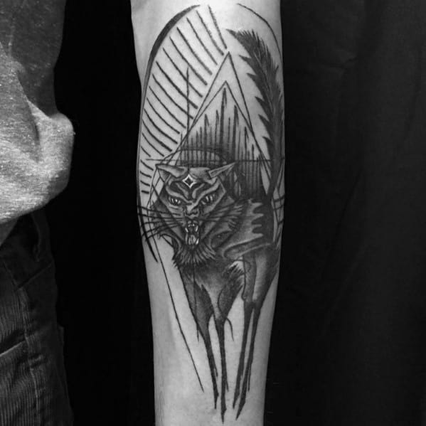 Dark abstract cat tattoo with sharp geometric elements and intense shading, creating a fierce and mystical design on the forearm.