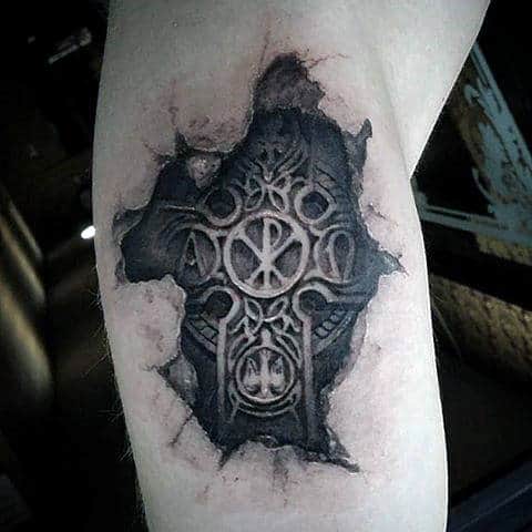 Tattoo of a torn skin revealing an intricate geometric design on the upper arm