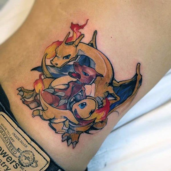 Tattoo trio of Charmander, Charmeleon, and Charizard in a fiery spiral design, placed on the side torso with dynamic motion.