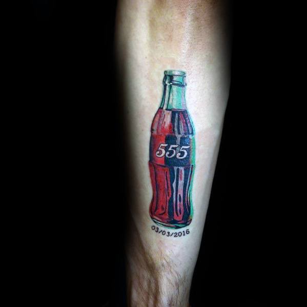 Personalized Coca-Cola bottle tattoo with a bold red and black design, featuring the number "555" and a date for a meaningful and unique touch.