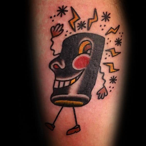 Old-school style tattoo of an animated VHS tape with a big smile, red cheeks, and lightning bolts, blending retro tech with cartoon charm.