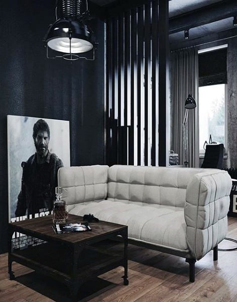 Masculine modern living room with tufted sofa, industrial lighting, and black decor accents.