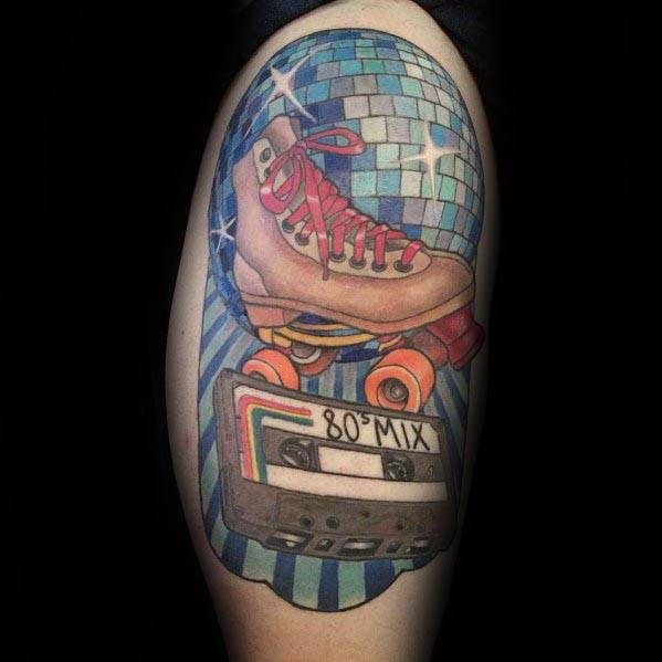 Retro-themed tattoo featuring a disco ball, roller skate, and '80s mix' cassette tape, blending nostalgia and vibrant colors in a bold design.