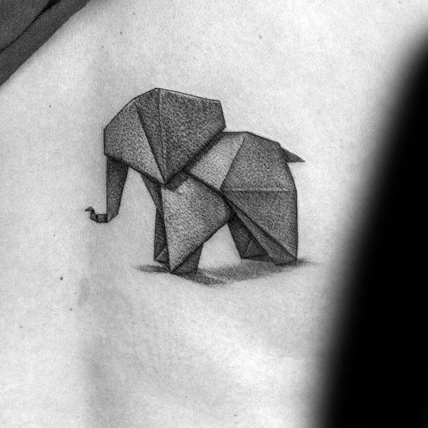 Origami-style elephant tattoo in black and gray on skin.