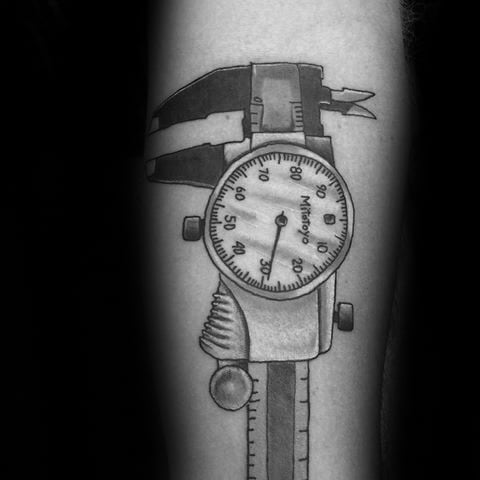 Tattoo of a detailed dial caliper showing precise measurement markings, symbolizing accuracy and craftsmanship, shaded realistically on the arm.