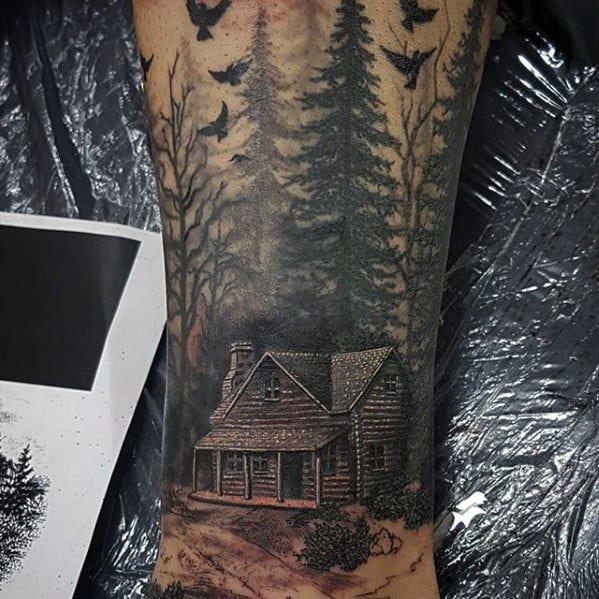 Dark and detailed Evil Dead tattoo of the iconic cabin in a shadowy forest, surrounded by towering trees and ominous flying crows above