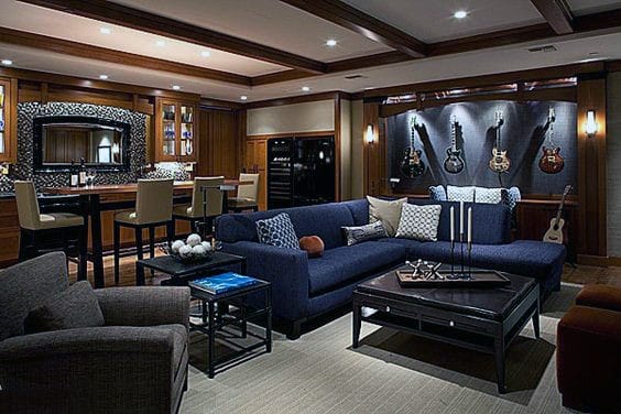 masculine man cave basement guitars on display bar blue sofa