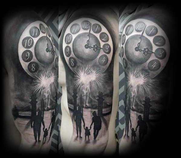 Black and grey tattoo featuring a large clock striking midnight, fireworks bursting in the sky, and a family silhouette walking toward a gate.