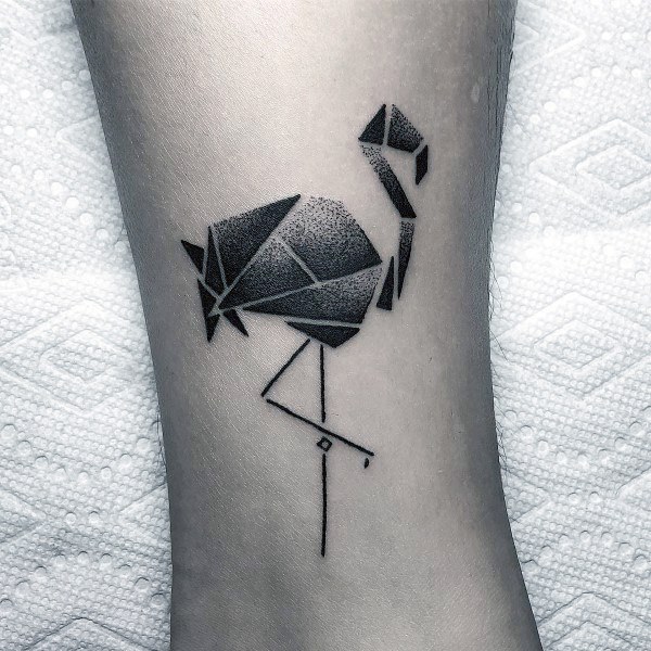 Minimalist origami-style flamingo tattoo in black ink with dotwork shading and clean geometric lines for a sleek and modern look.