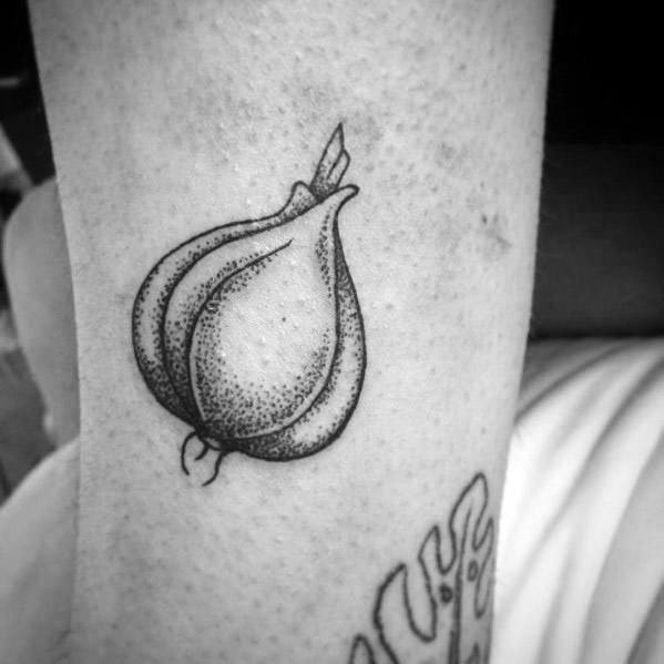 Small black and grey garlic tattoo with fine dotwork shading and bold outlines, creating a simple yet detailed botanical design.