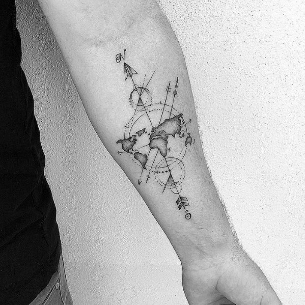Forearm tattoo of a world map, geometric lines, and compass rose on light skin