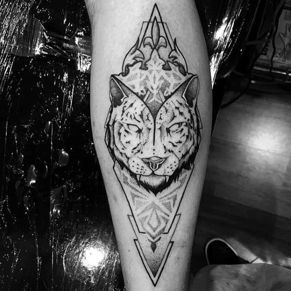 Forearm tattoo of a tiger with fine dotwork shading, symmetrical geometric patterns, and ornamental accents framed in a sharp triangular shape.