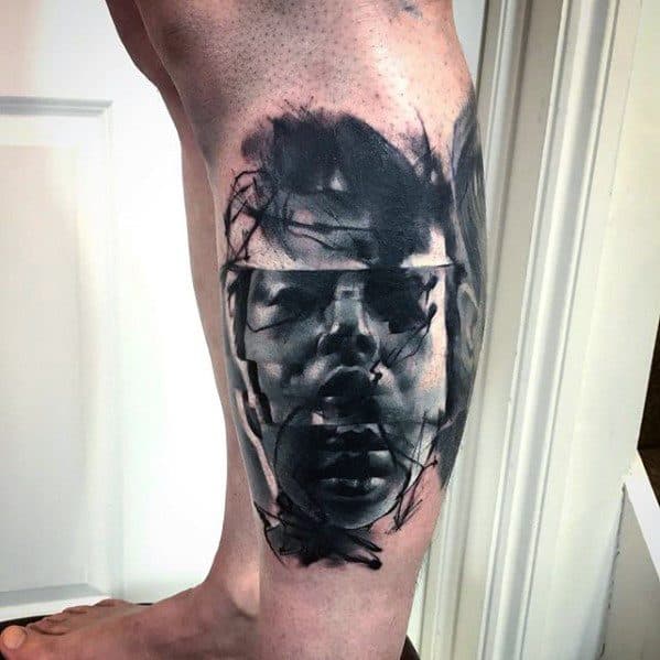 Abstract glitch tattoo of a male face in grayscale with layered, overlapping expressions and chaotic brushstroke-like textures for a haunting effect