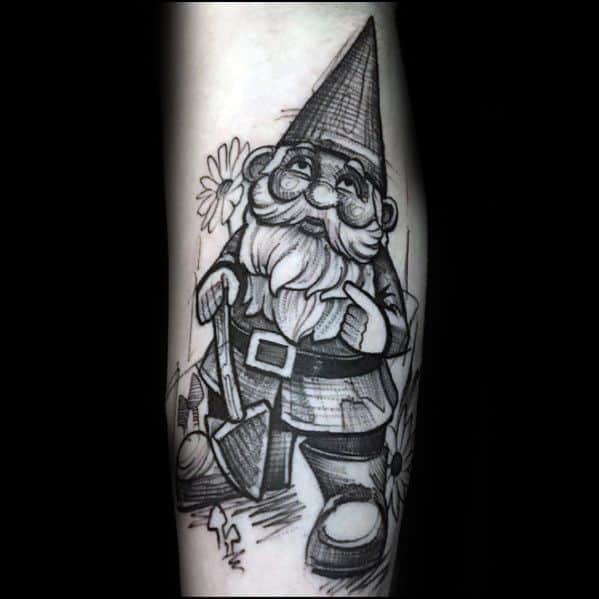 Black and white tattoo of a classic garden gnome with a tall hat, glasses, and a bushy beard, holding a shovel and surrounded by flowers.