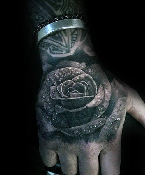 Black rose tattoo with white highlights on a hand