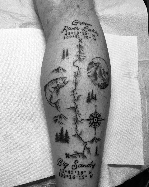 This tattoo showcases a detailed map from Green River Lakes to Big Sandy, featuring coordinates, a fish, mountains, trees, and a compass.