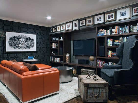 home living room orange sofa accent chair framed photos bookshelf 