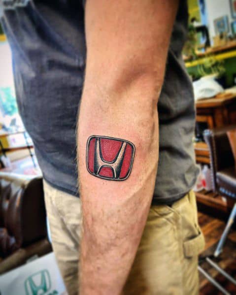 Bold red Honda logo tattoo on a man's arm, featuring a three-dimensional effect with black shading and clean detailing.