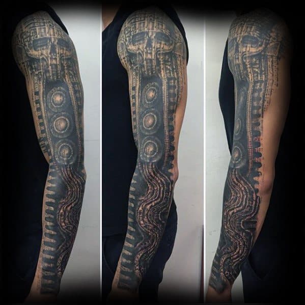 HR Giger-style full-sleeve tattoo with biomechanical circuitry, skeletal patterns, and intricate alien-inspired textures in dark tones.