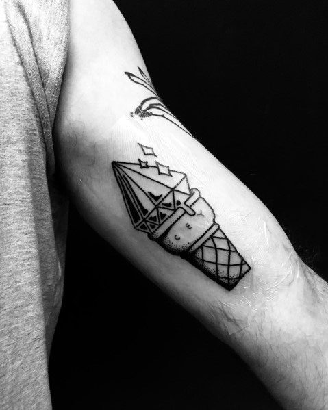Black ink tattoo of an ice cream cone with a geometric crystal scoop, featuring clean lines and minimal shading for a modern and abstract design.