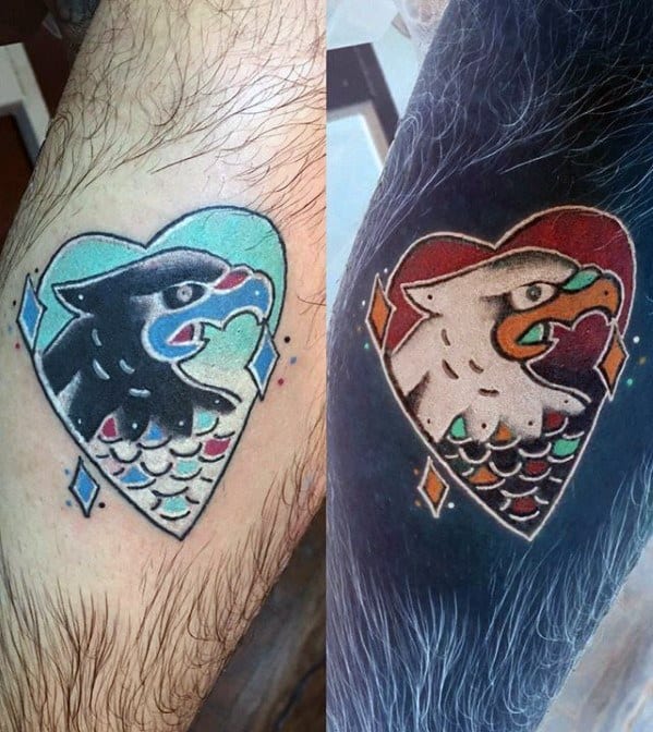 Inverted traditional-style eagle tattoo inside a heart shape, shifting from bold black and teal to bright white and red tones.