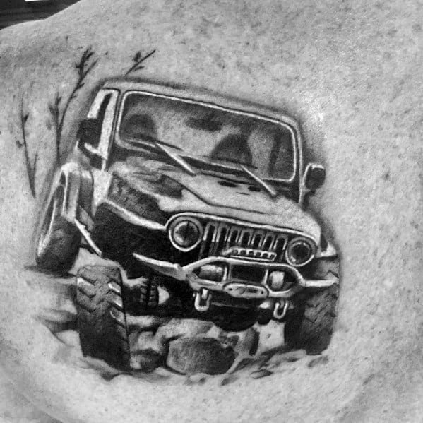 Realistic black and grey tattoo of an off-road Jeep navigating rocky terrain, featuring detailed shading and depth for a rugged adventure look.